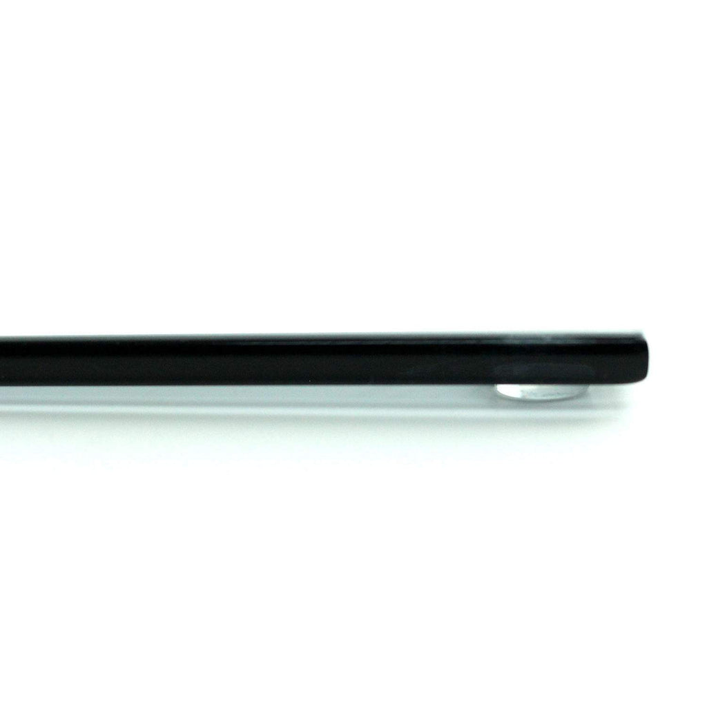 Rectangular gray glass burner cover, side edge close-up with dark trim