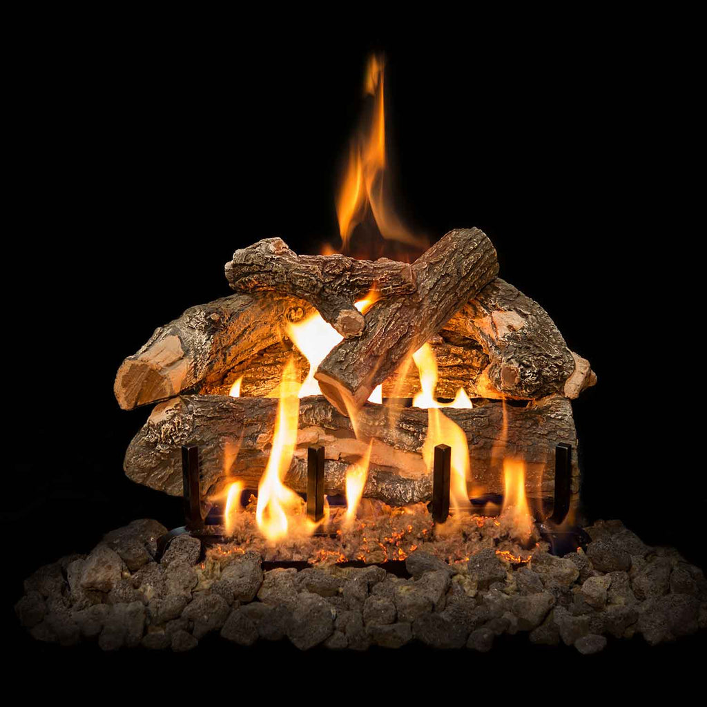 Double-sided gas logs with stacked weathered oak pieces, flames rising from a rock base