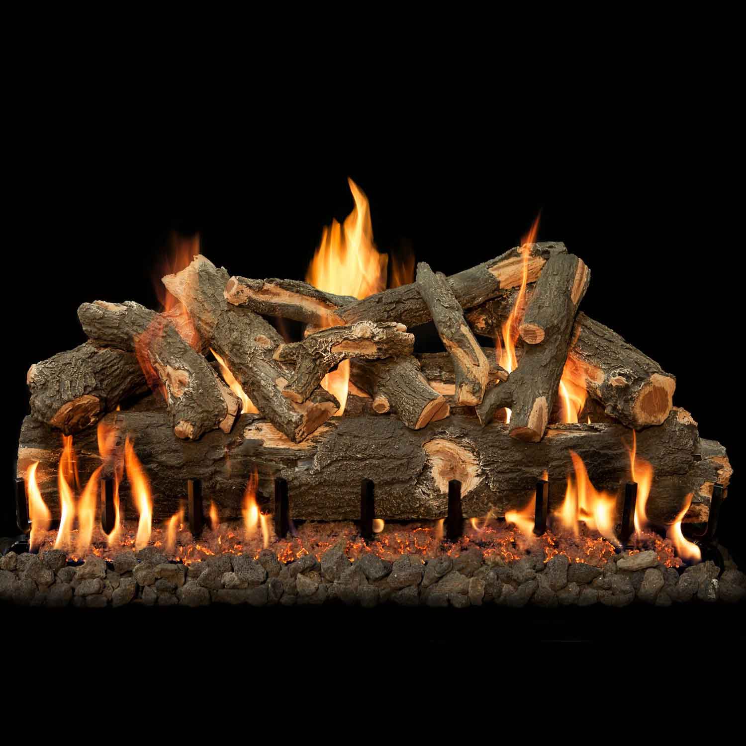 Gas fire logs with weathered oak pieces and flames along the front and sides over rocks