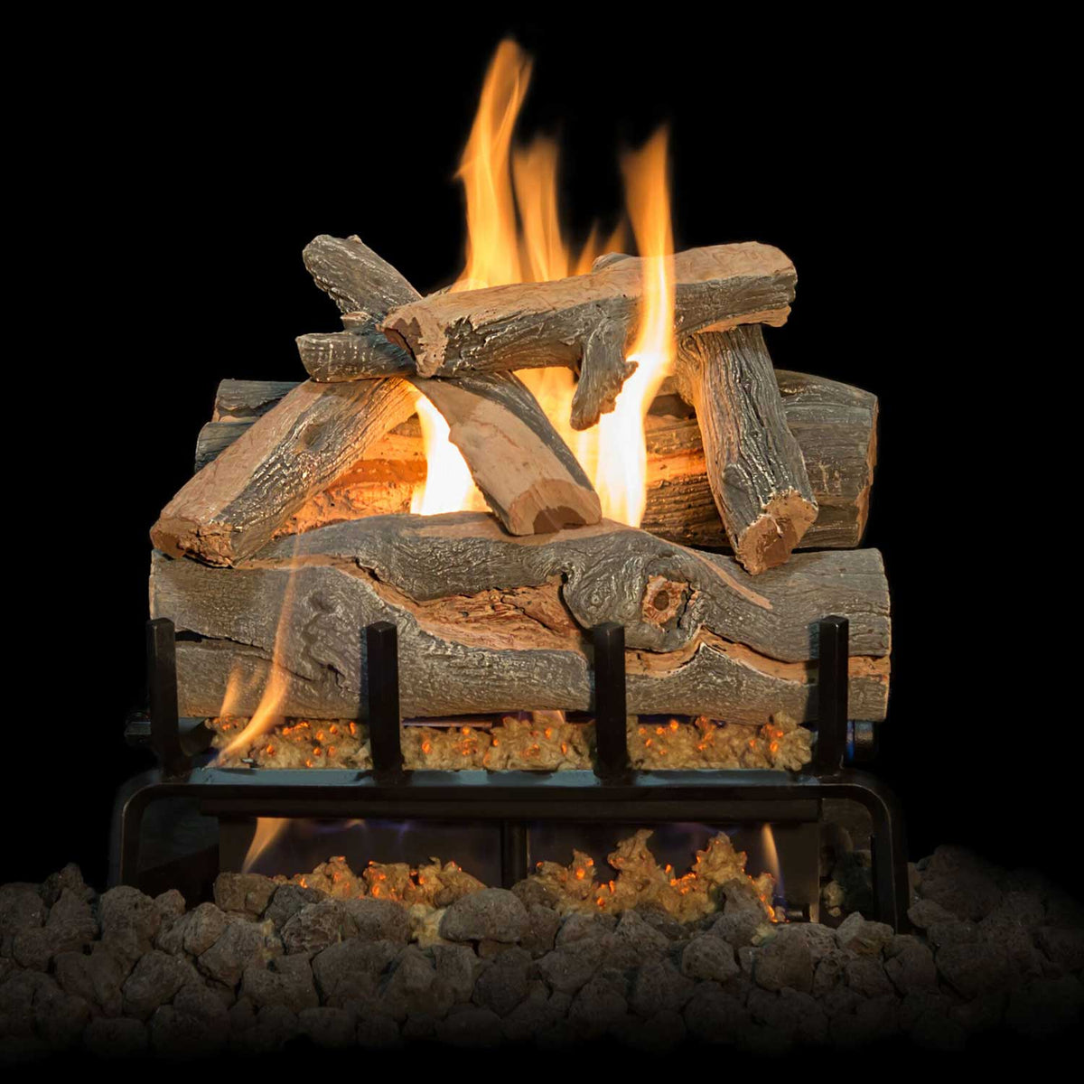 Gas log set with flames rising above log bed on metal grate, with burner pan visible