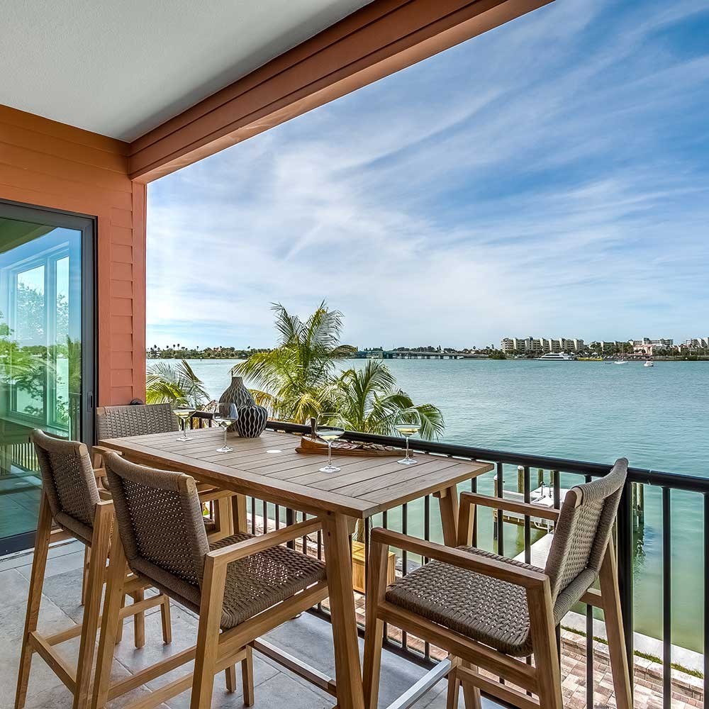 Teak counter-height dining table with 4 woven chairs and light wood frames