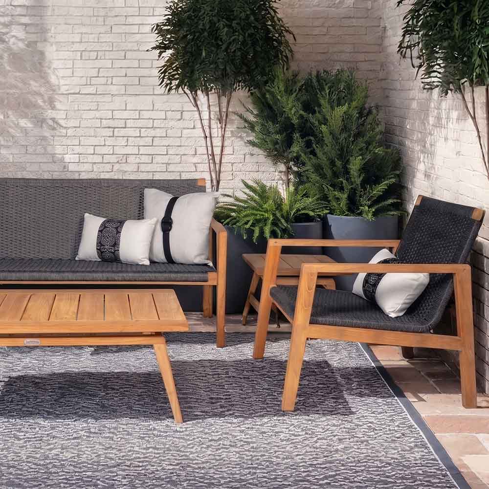 Charcoal outdoor seating set with cushioned sofa, armchairs, and wood coffee table
