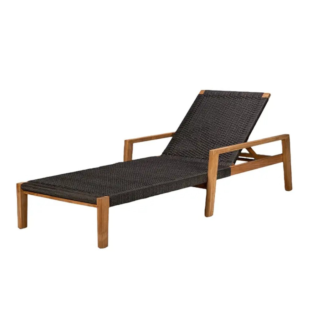Outdoor lounge chair with dark charcoal cushion, slanted headrest, teak-style frame