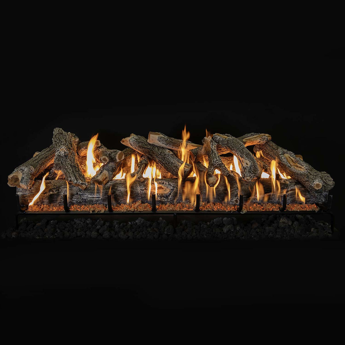 Vented gas log set with weathered oak logs on burner grate, flames across front