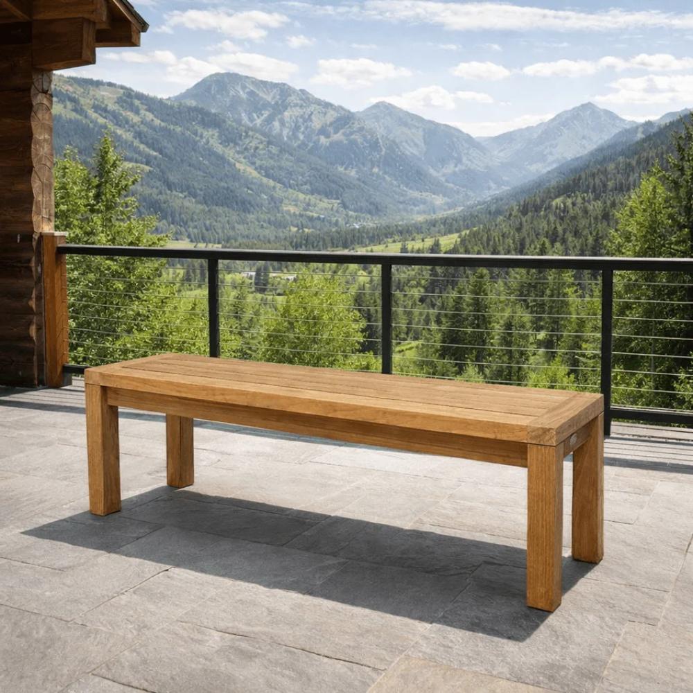 Solid teak dining bench in side view with rectangular top and tapered legs