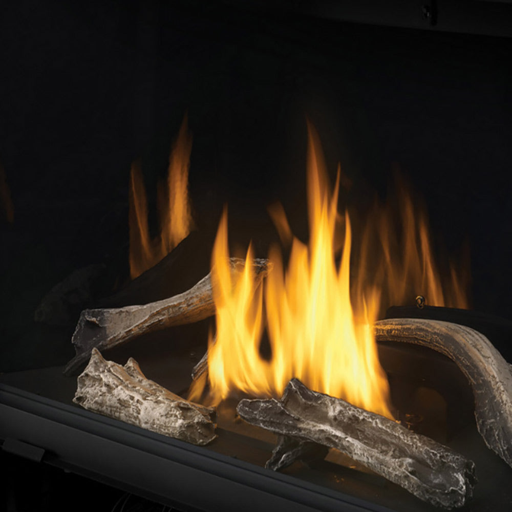 Firewood log set with bright flames in a black firebox.