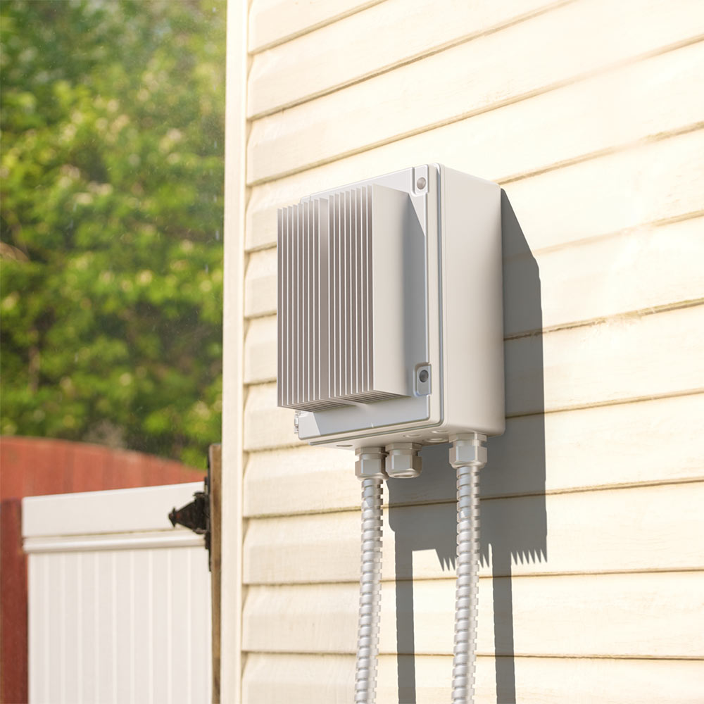 Two-channel smart-heater dimmer controller mounted on outdoor wall with conduit cables