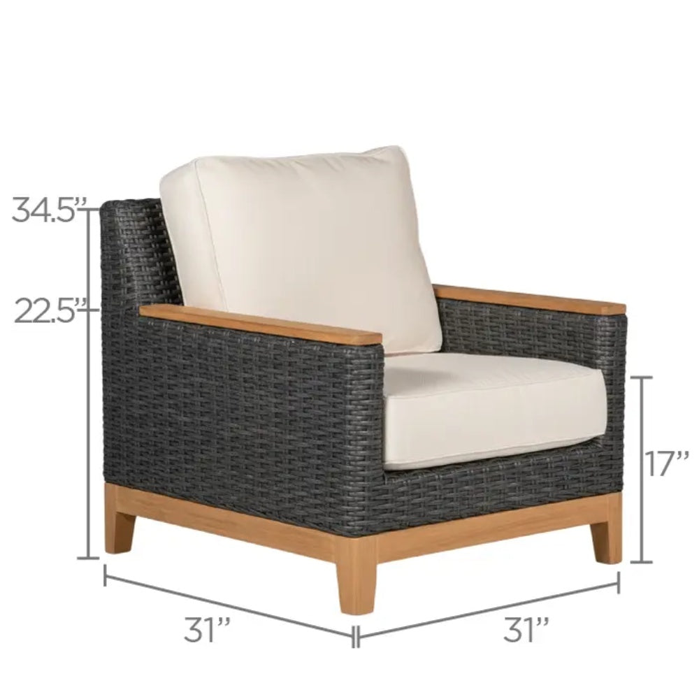 Patio armchair with dark wicker frame and light cushion with tall, rounded backrest