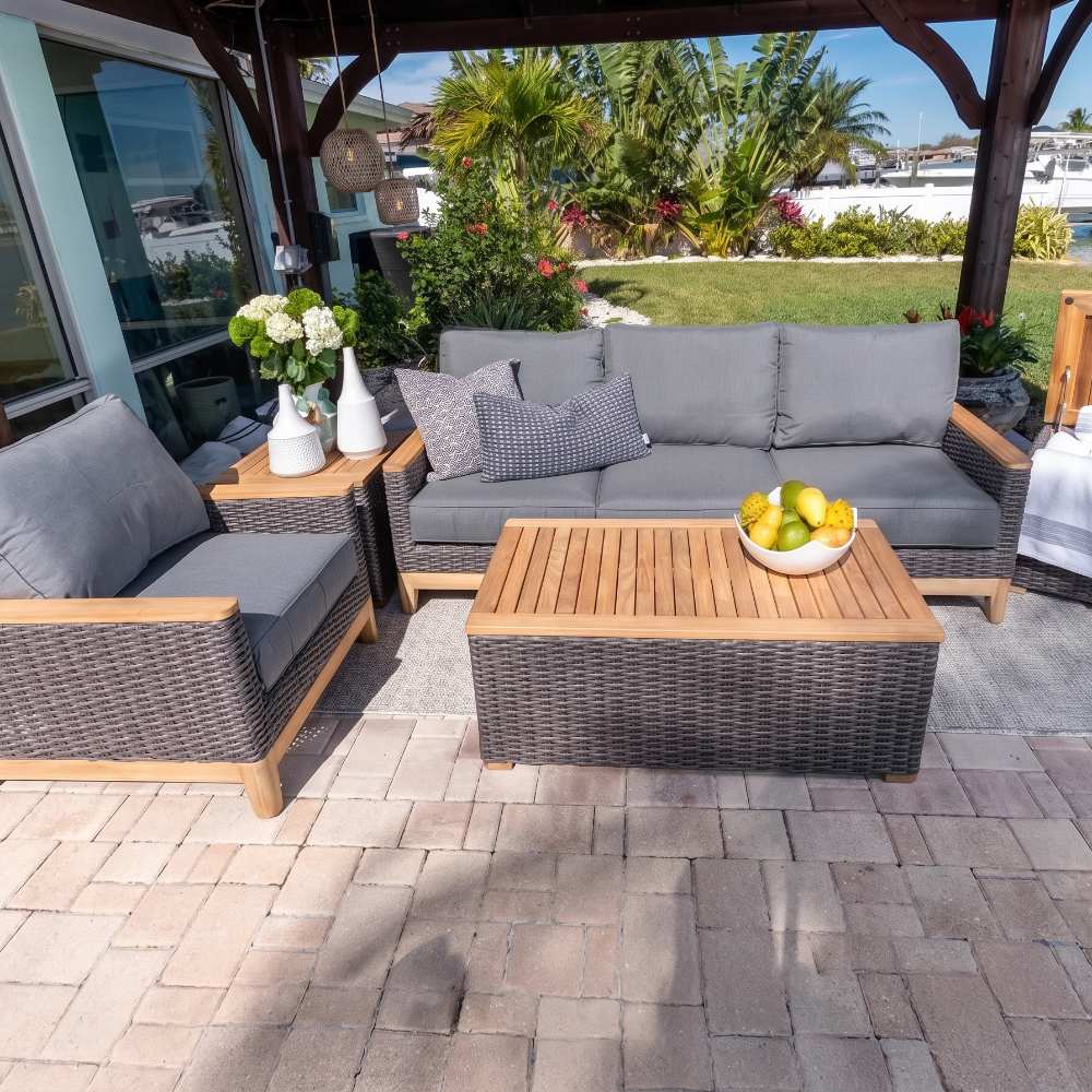 Charcoal wicker corner sofa with gray cushions and two seat sections