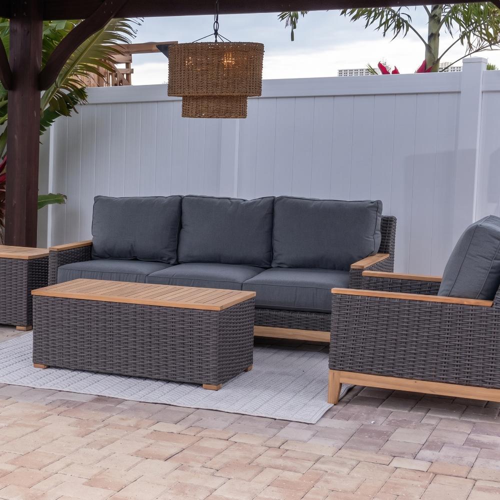 Charcoal wicker outdoor sofa with dark gray cushions and seat back pillows