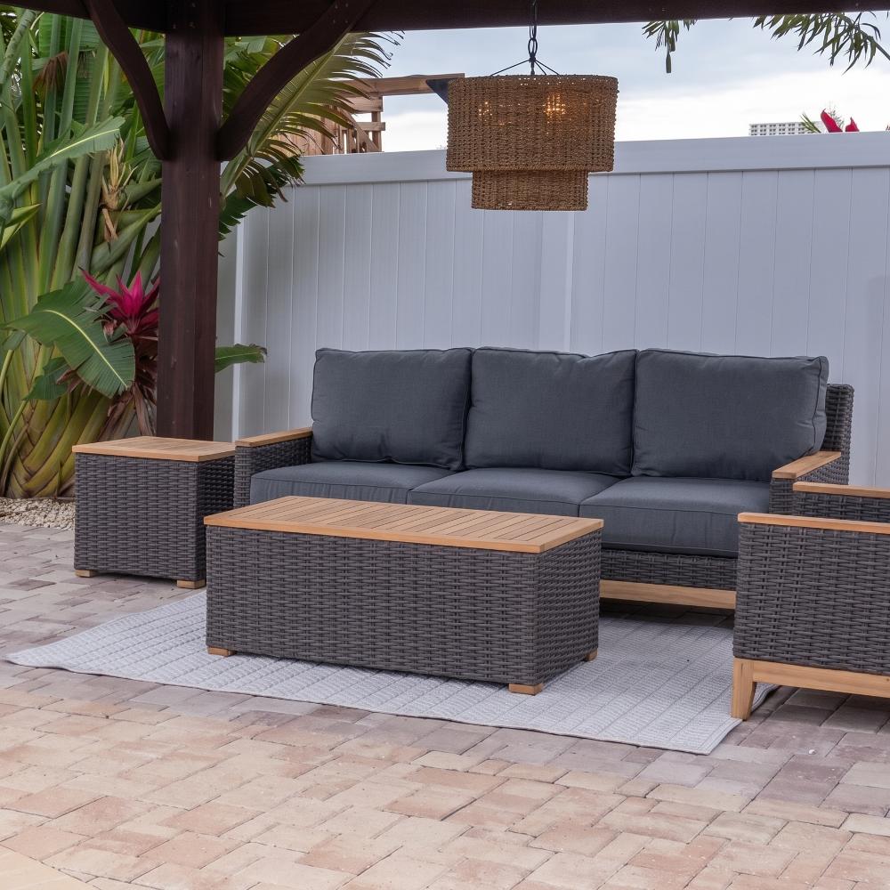 Outdoor coffee table with dark woven frame and light wood tabletop