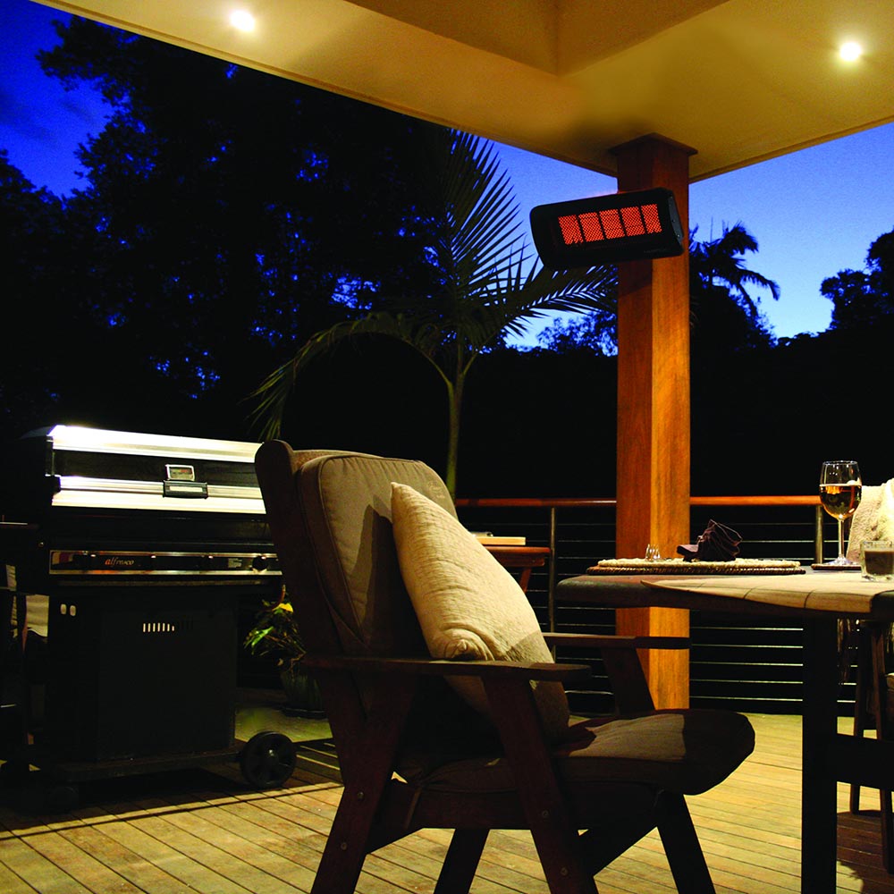 Outdoor radiant gas heater with glowing red burner grid mounted on patio