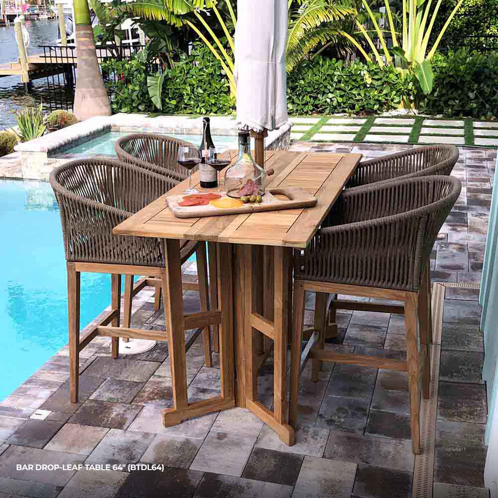 Rectangular teak bar table with hinged drop-leaf top and slatted surface, natural brown.