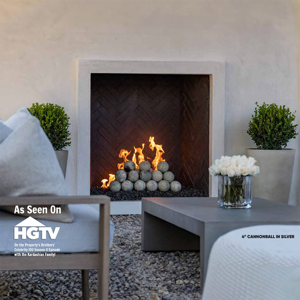 4-inch silver cannon balls arranged in front of a lit fireplace