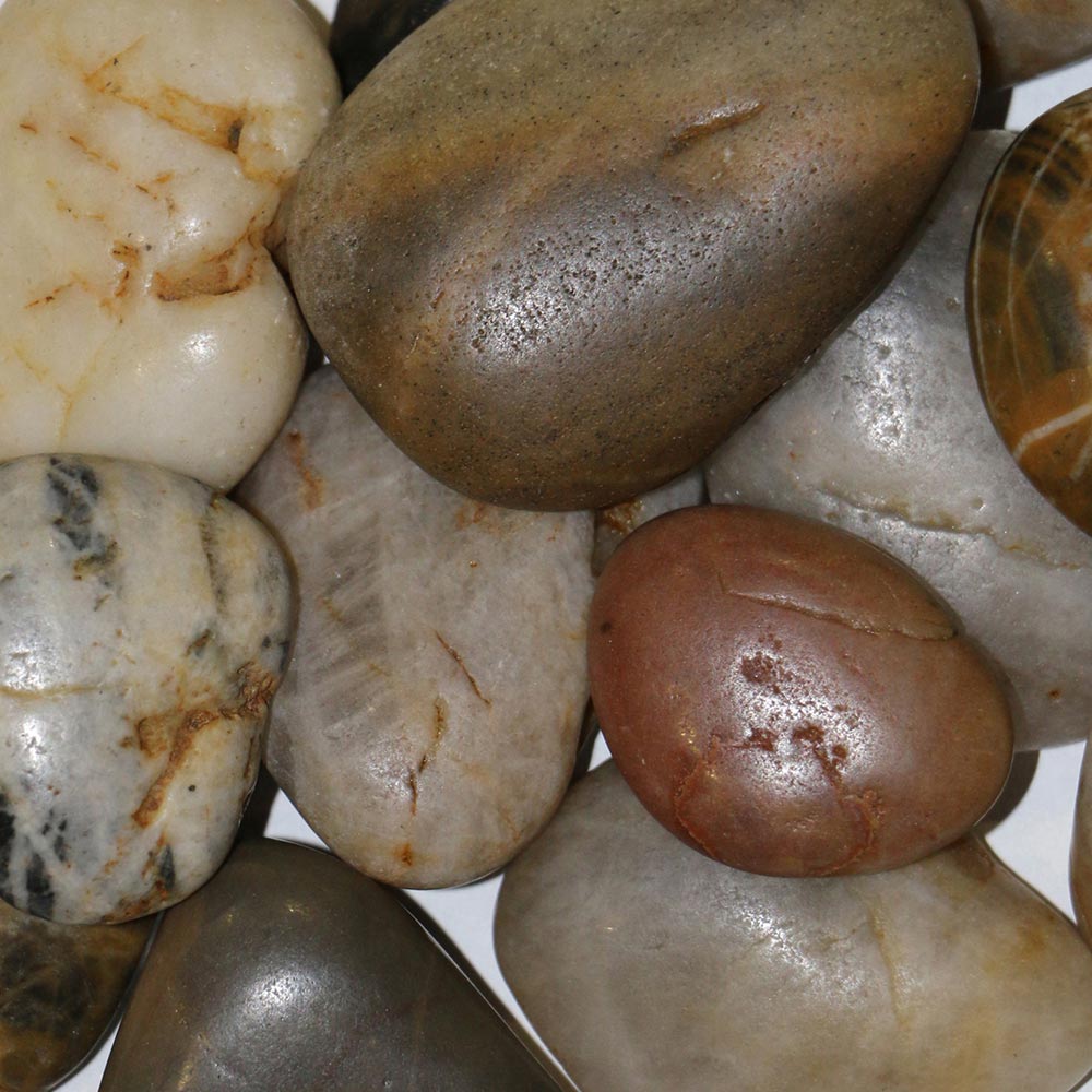 Dimplex river rock media with assorted smooth stones in cream, gray, and brown.