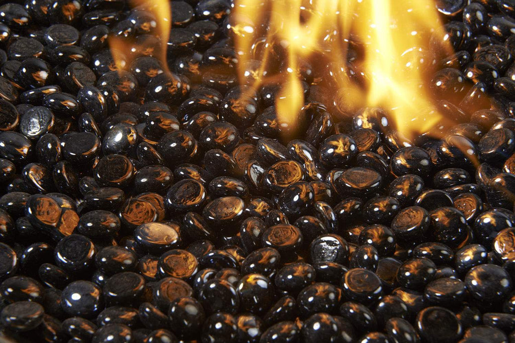 Flame-lit onyx fire glass gems, glossy black oval crystals