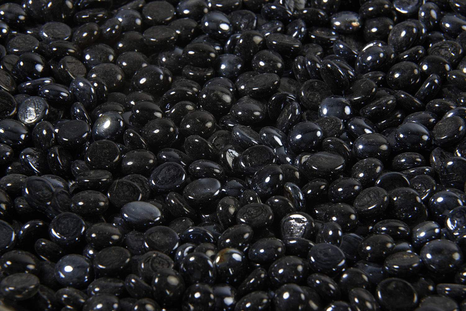 Onyx fire glass gems, glossy black oval crystals