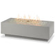 Light grey linear gas fire pit table with flames over decorative fire glass
