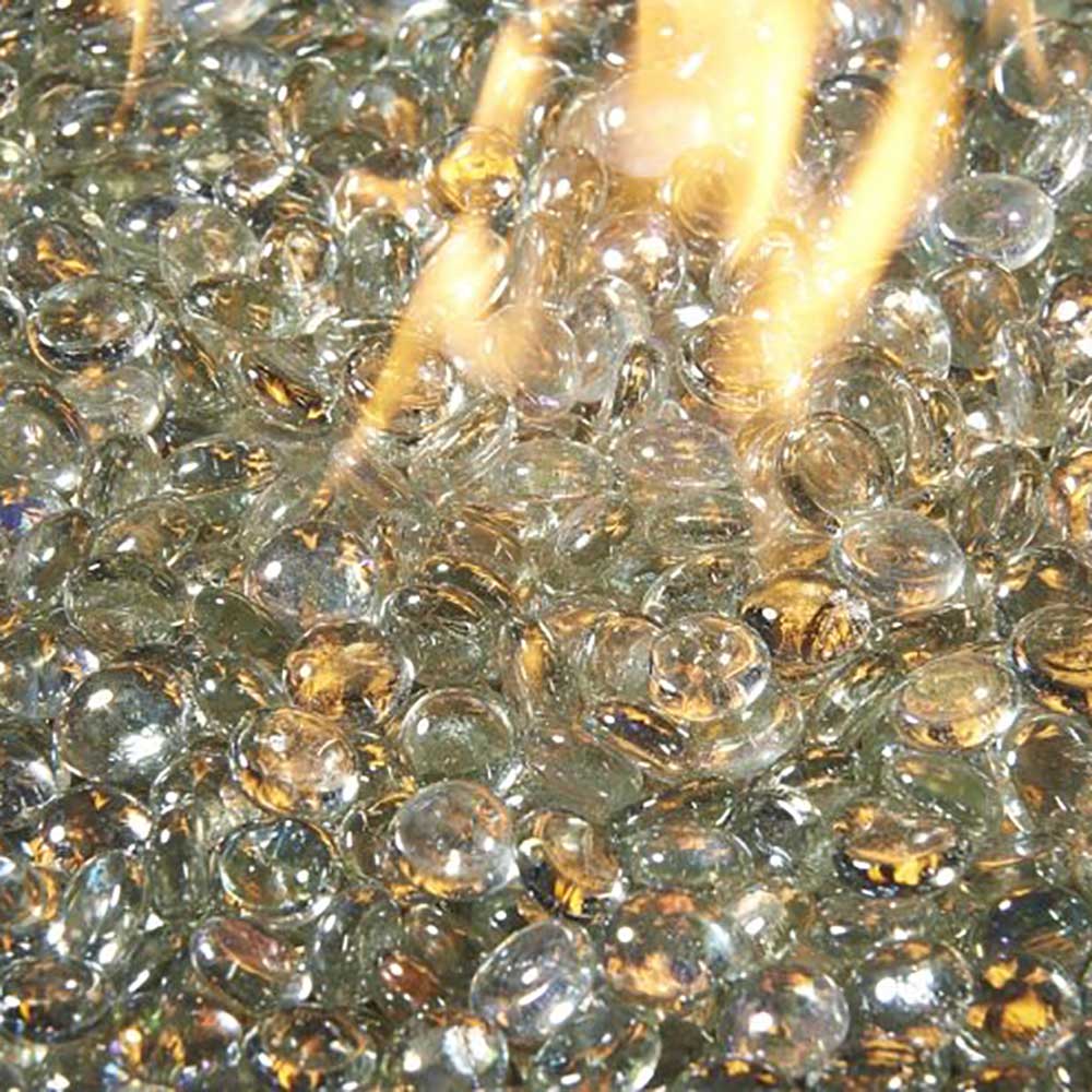 Glass fire pit gems in clear and gold tones with visible flames