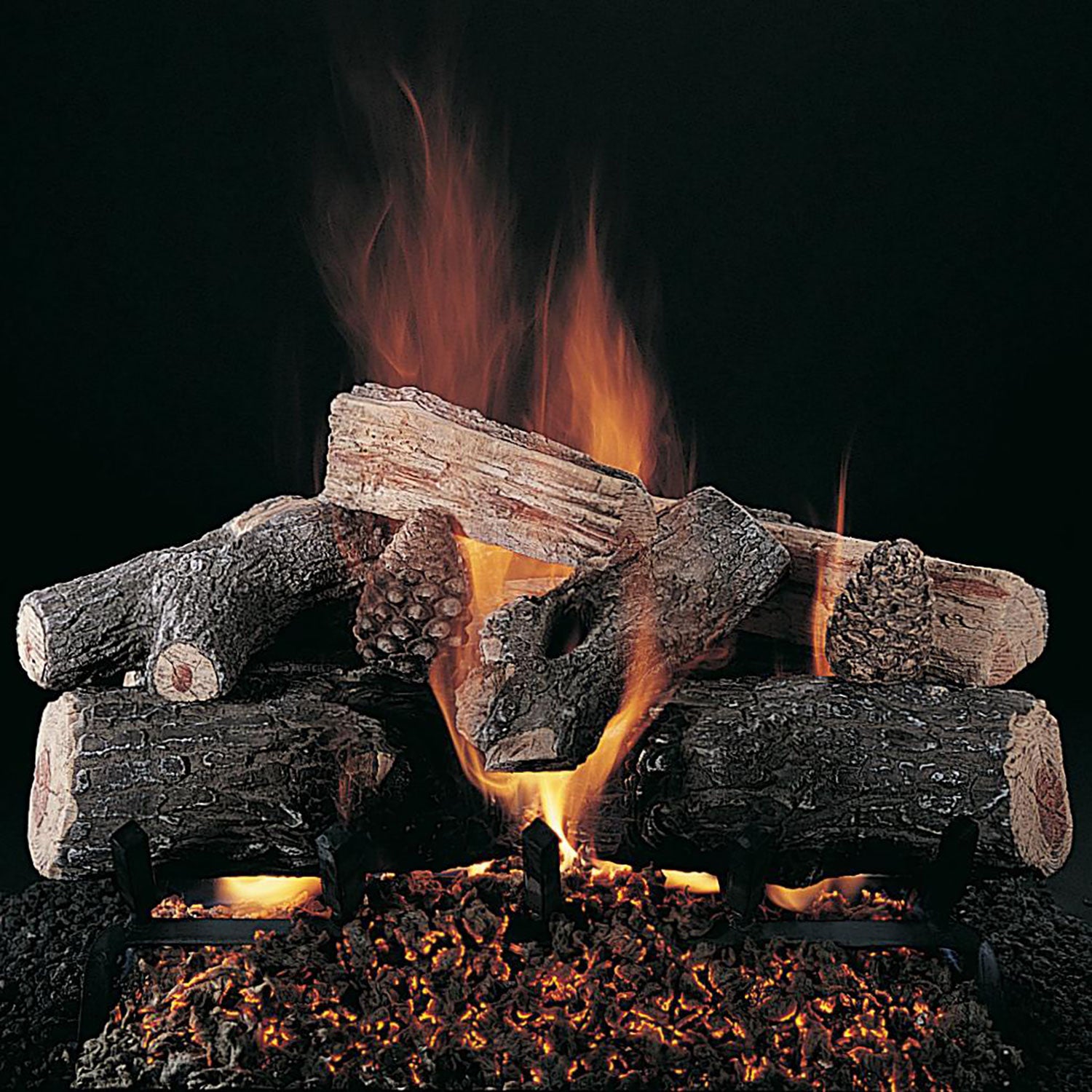 Gas log set with faux stacked logs and orange flames over dark ember bed