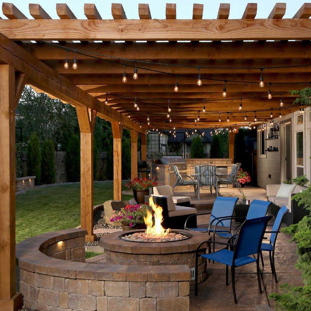 Outdoor stone gas fire pit with lit burner and central flame