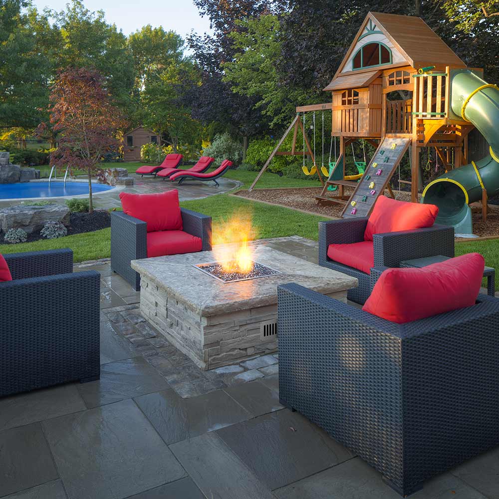 Outdoor patio square fire pit showing flame from match-light burner kit