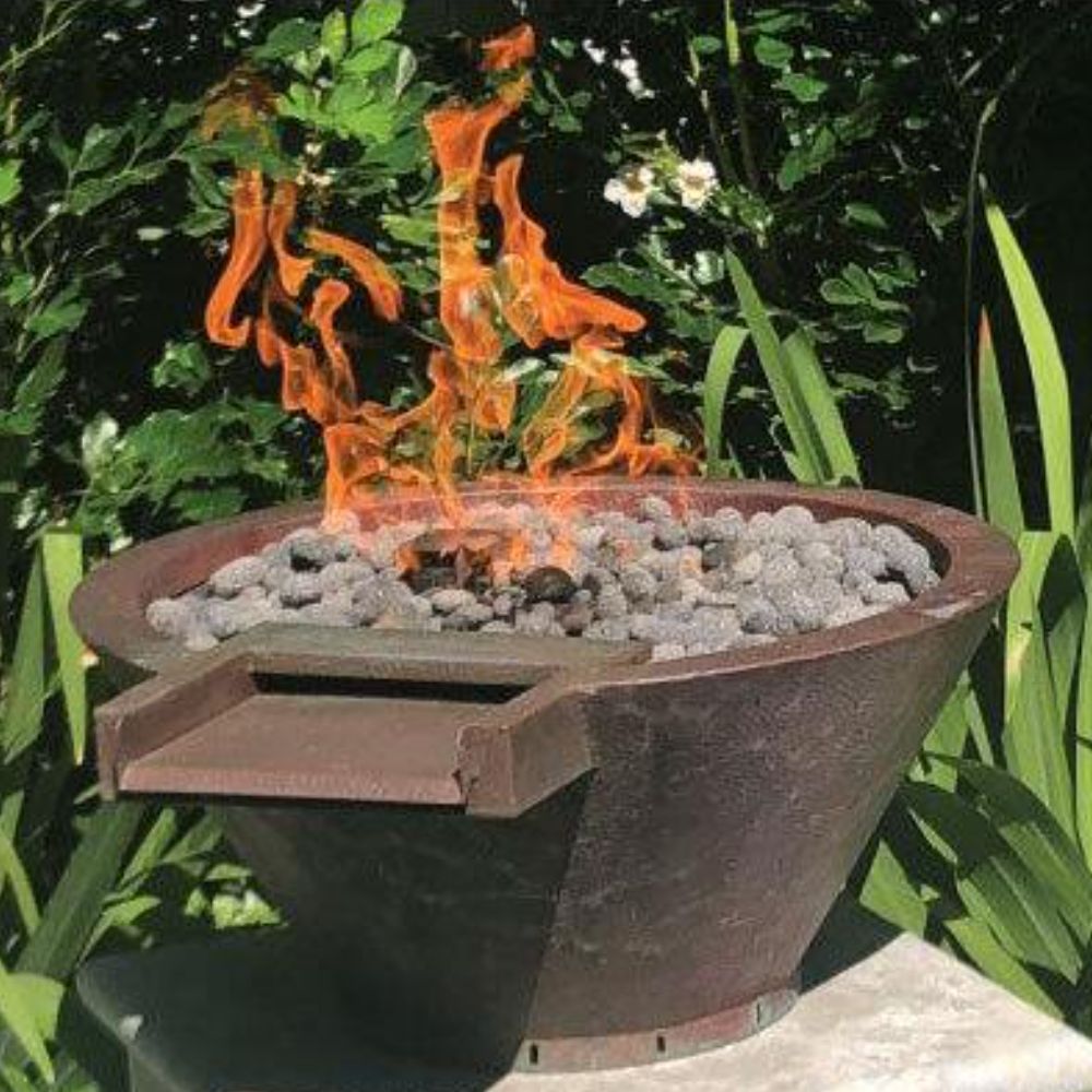 Round hammered copper gas fire and water bowl with visible flame above rocks