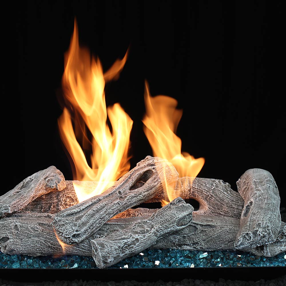 Vented gas log set with driftwood-style logs and burning flames