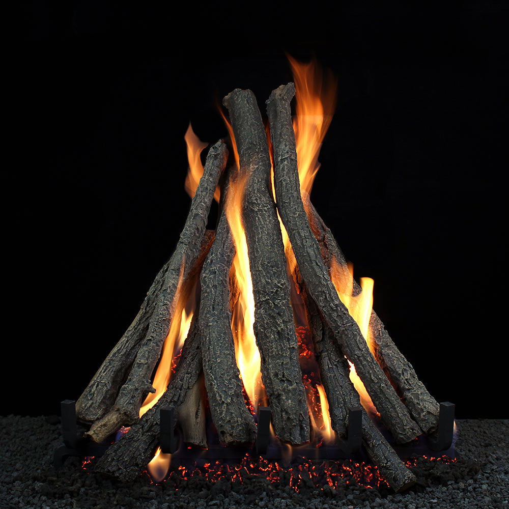 Vented gas fireplace logs with stacked dark wood pieces and visible flames