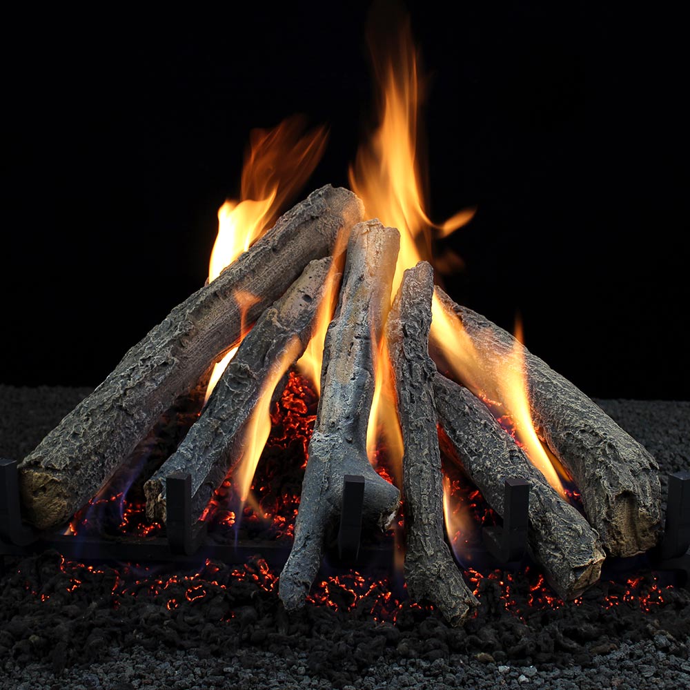 Burning vented gas log set with stacked gray logs and orange flames