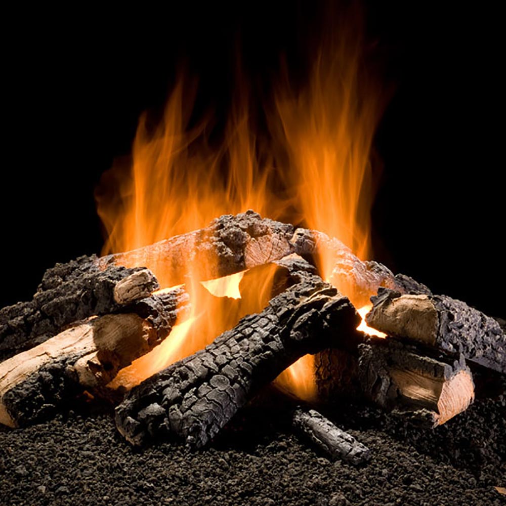 Charcoal gas log set with glowing flames and dark, split logs