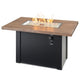 Linear gas fire table, driftwood top and black base with lit glass burner