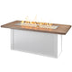 Linear gas fire table with wood-look top and white base, flames in clear burner tray