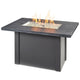 Linear gas fire table, carbon gray top and gray base with lit glass burner