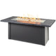 Linear gas fire table with charcoal gray top and dark base, burning flame in center