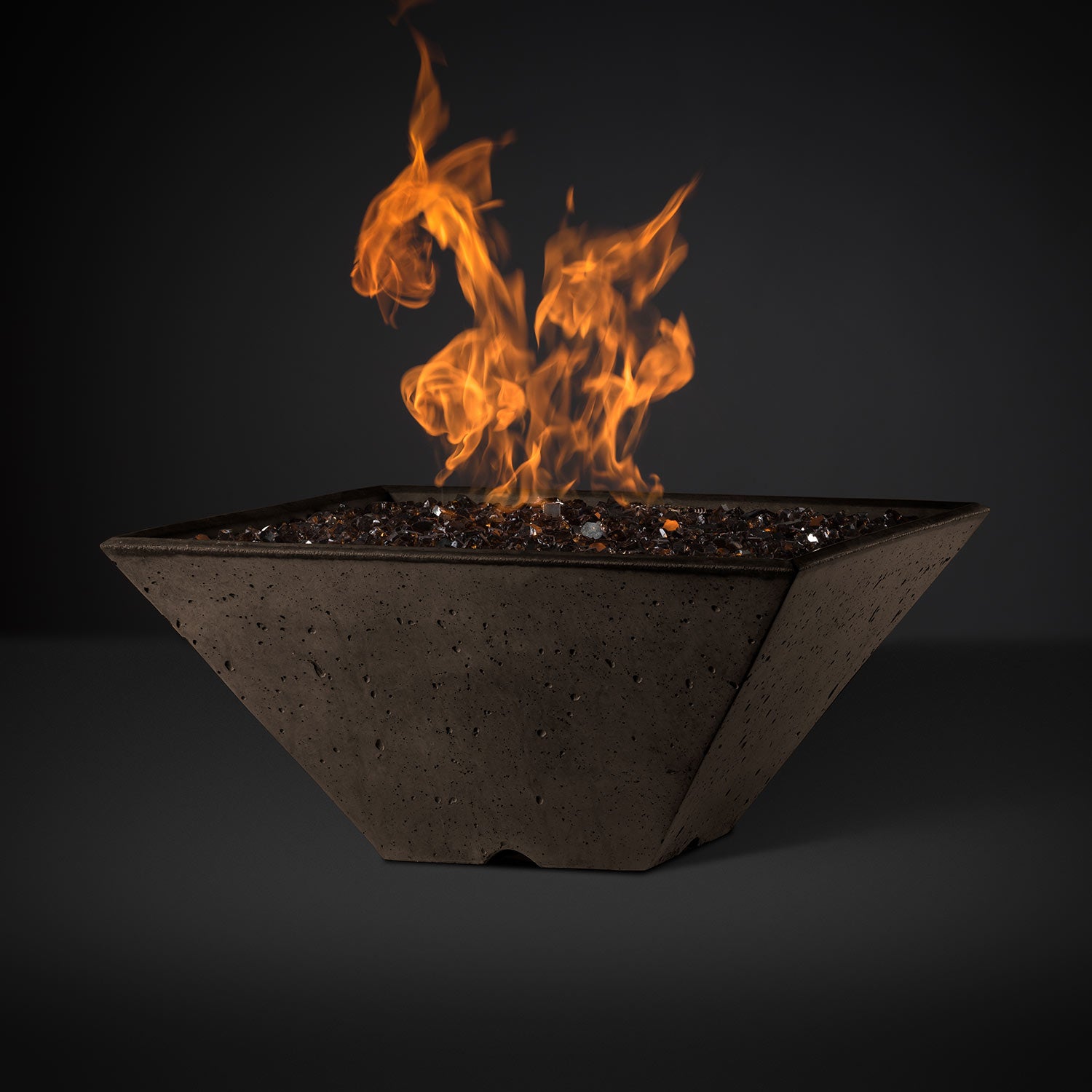 Square fire pit with orange flames and dark lava rocks in a brown basin