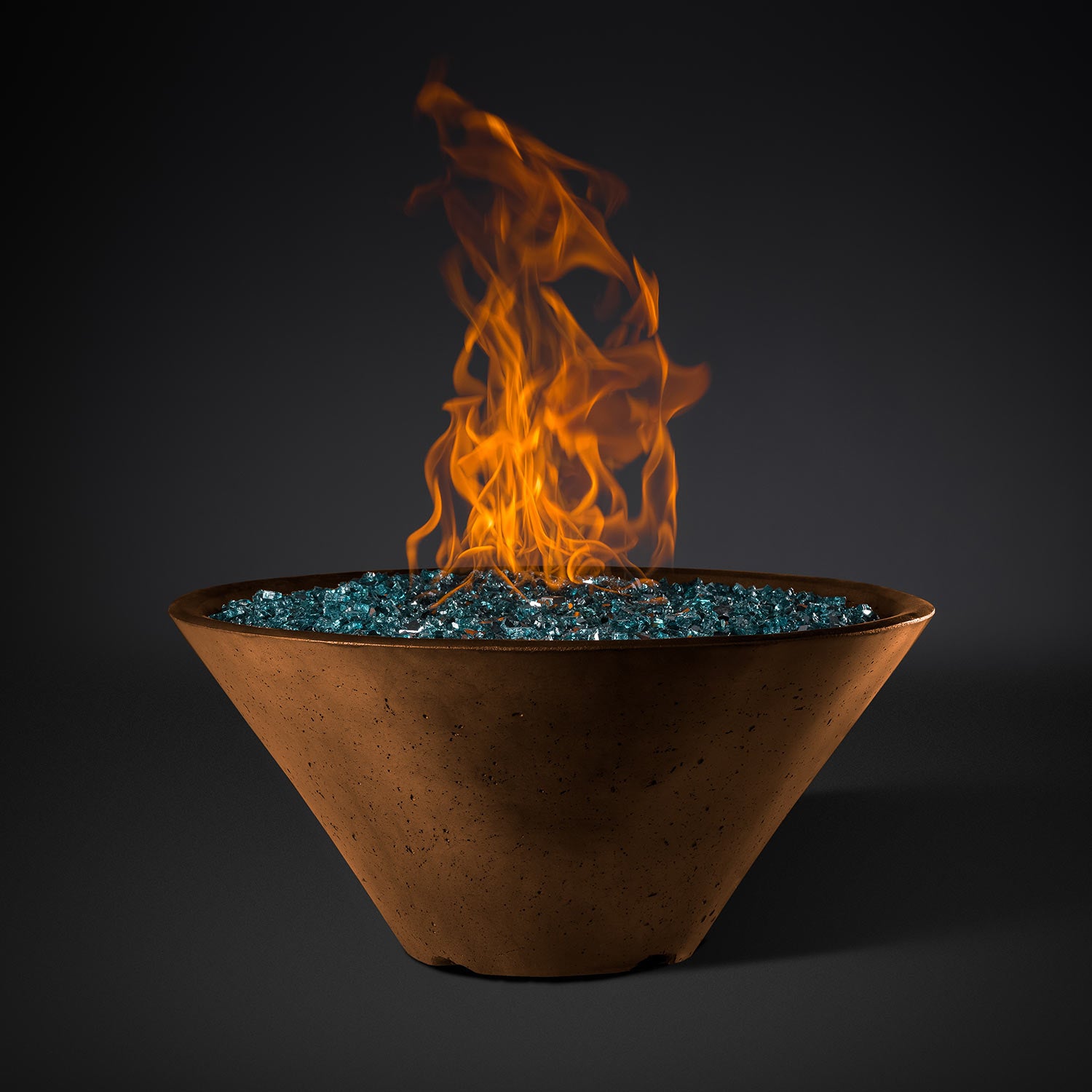 Dark brown round metal fire pit bowl with blue stone bed and orange flames