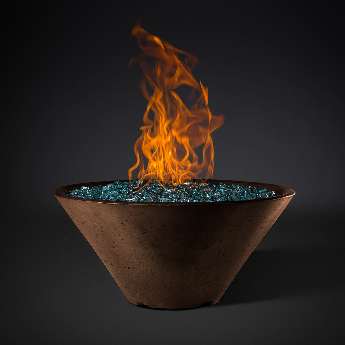 Round fire pit bowl with orange flames and teal fire-glass ring