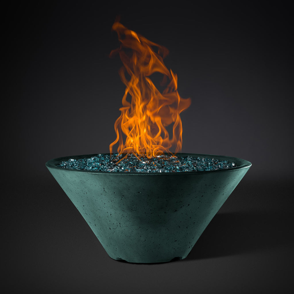 Round fire pit bowl with turquoise finish, blue glass rock base, and orange flames