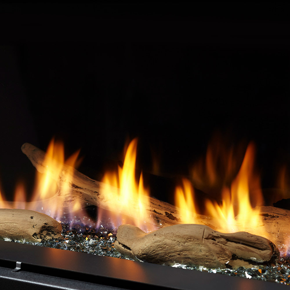 Majestic driftwood log set with glowing embers and visible flames in fireplace