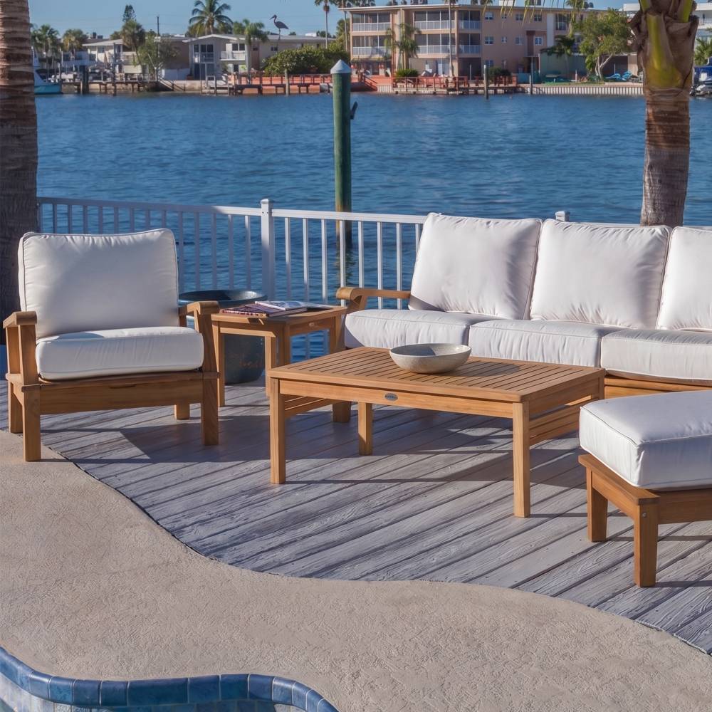 Teak outdoor seating set with white cushions and rectangular coffee table