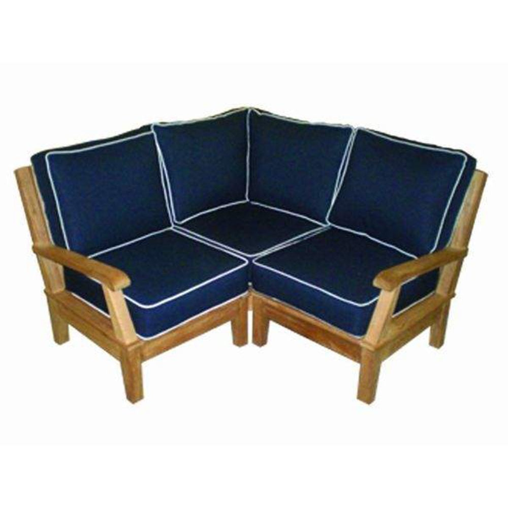 Small corner sectional sofa with navy cushions and white piping on light wood frame