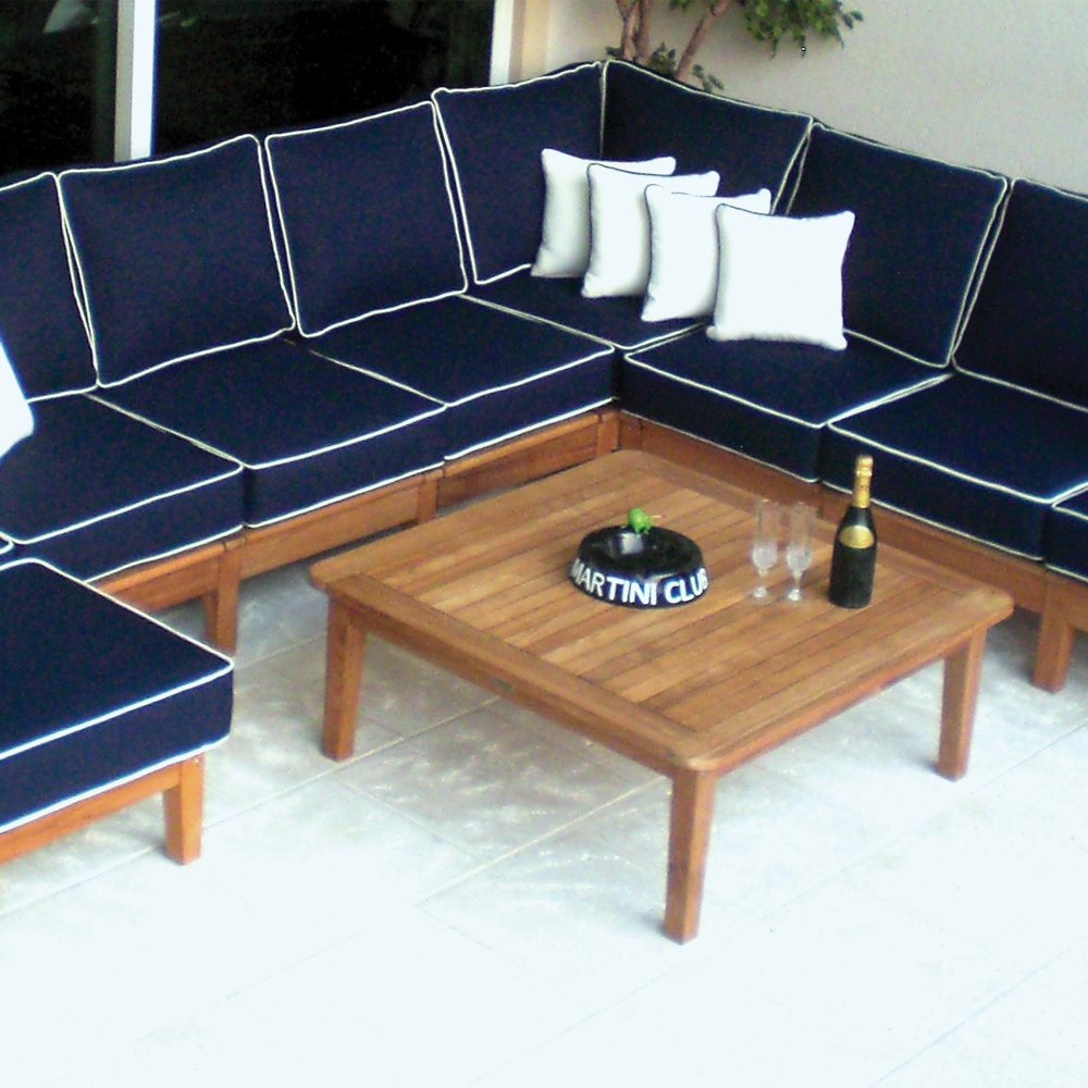 Dark navy sectional insert chair cushions with white piping and wood frame arms