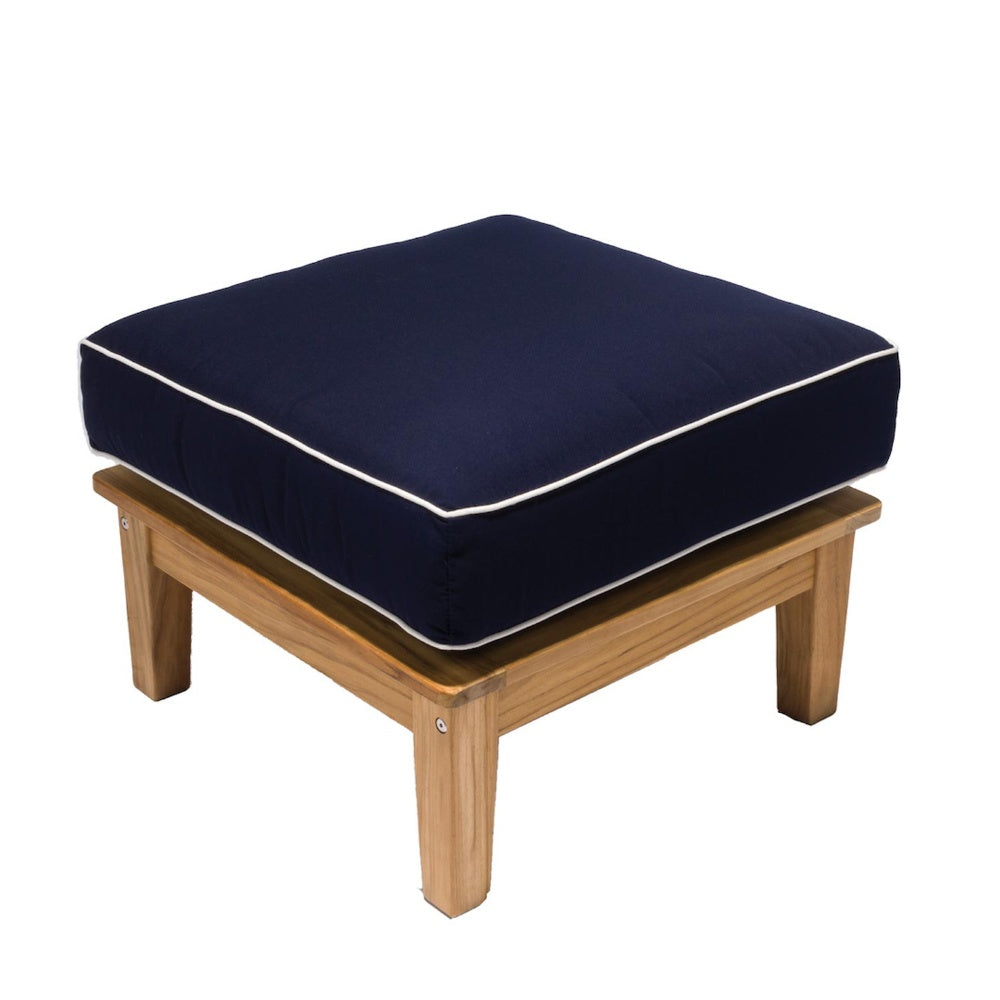 Teak outdoor ottoman with dark navy cushion and white piping on a square frame