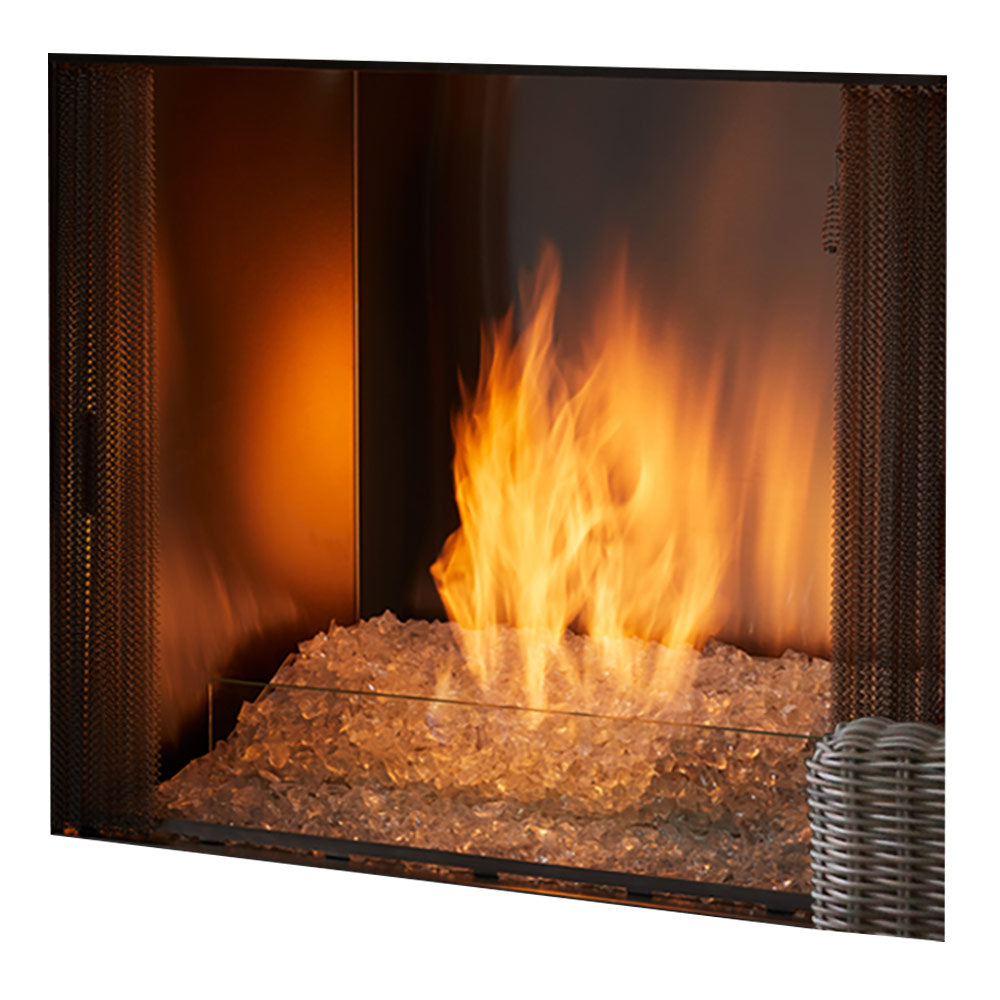 Contemporary outdoor natural gas fireplace with burning flames and stone fire bed