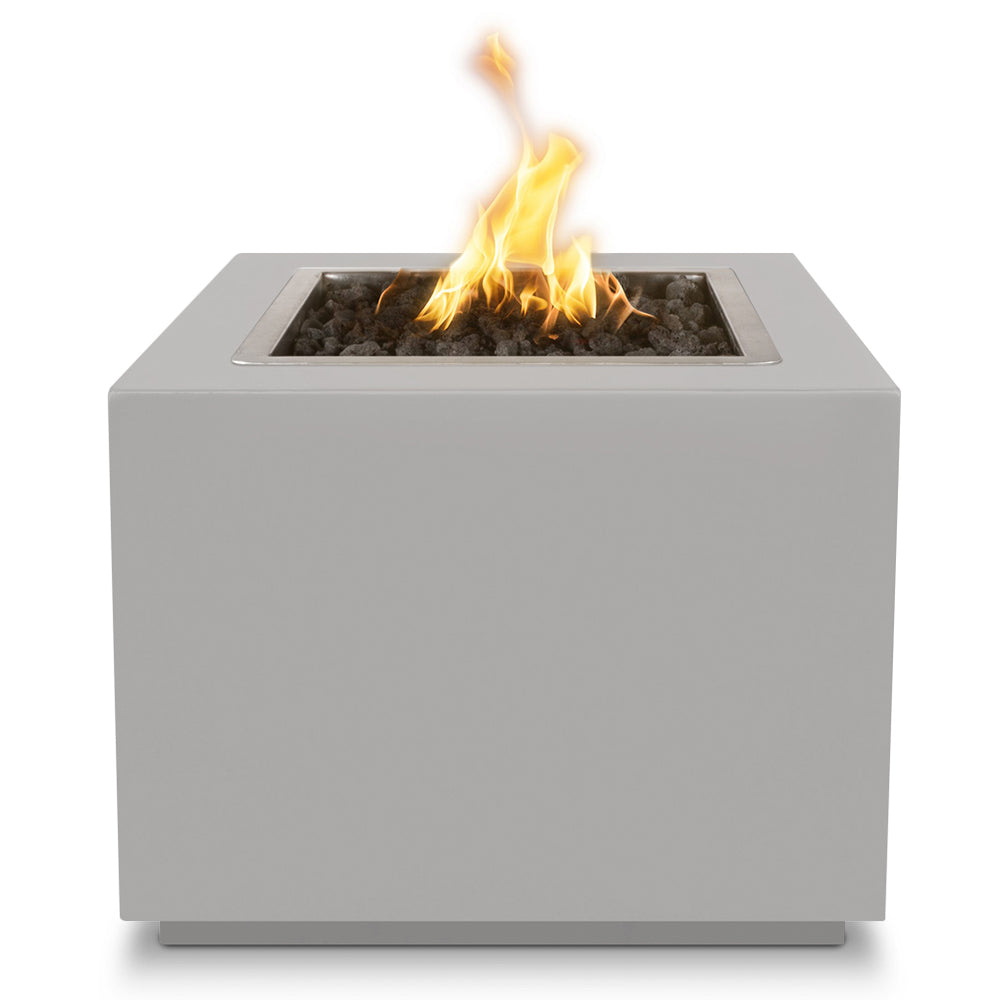 Light gray square gas fire pit with burning flames in a recessed black pan