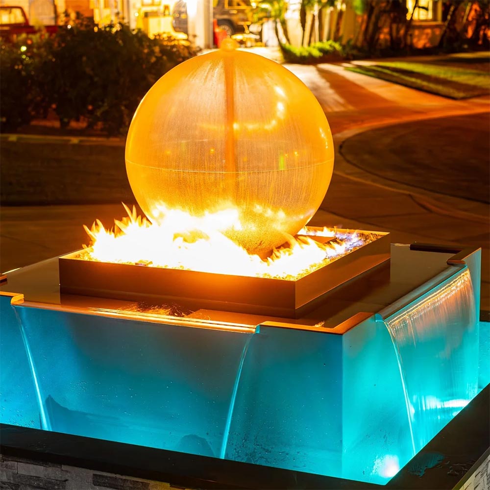 Square steel fire and water bowl with glowing sphere above lit blue water basin