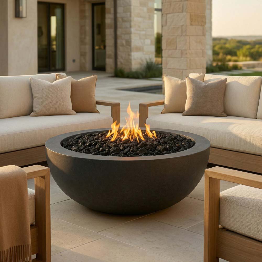 Round concrete gas fire pit with visible flames over dark fire media