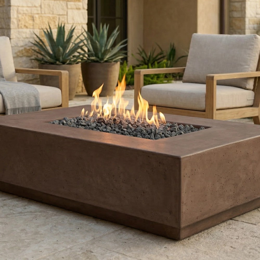 Cafe brown concrete gas fire pit with flames and black lava rocks