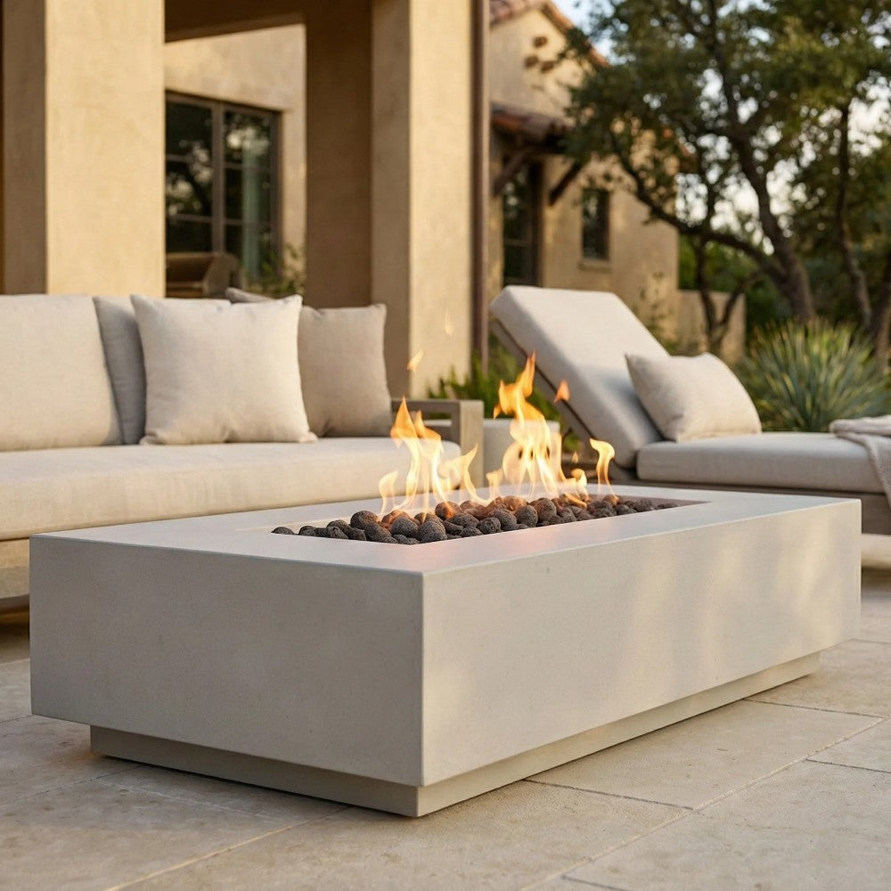 Light gray concrete gas fire pit with flames over black lava rocks